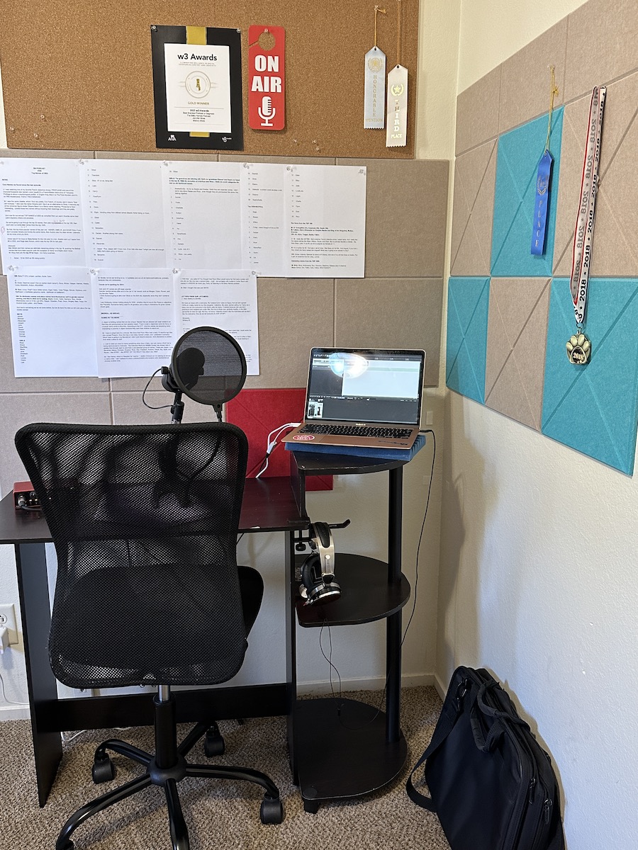 Corner of a room with wall pads, desk, computer, and microphone